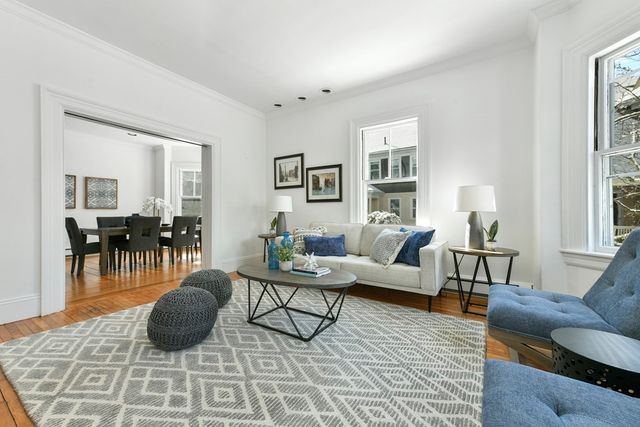 a living room with furniture rug and window