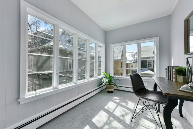 a dining room with furniture and windows