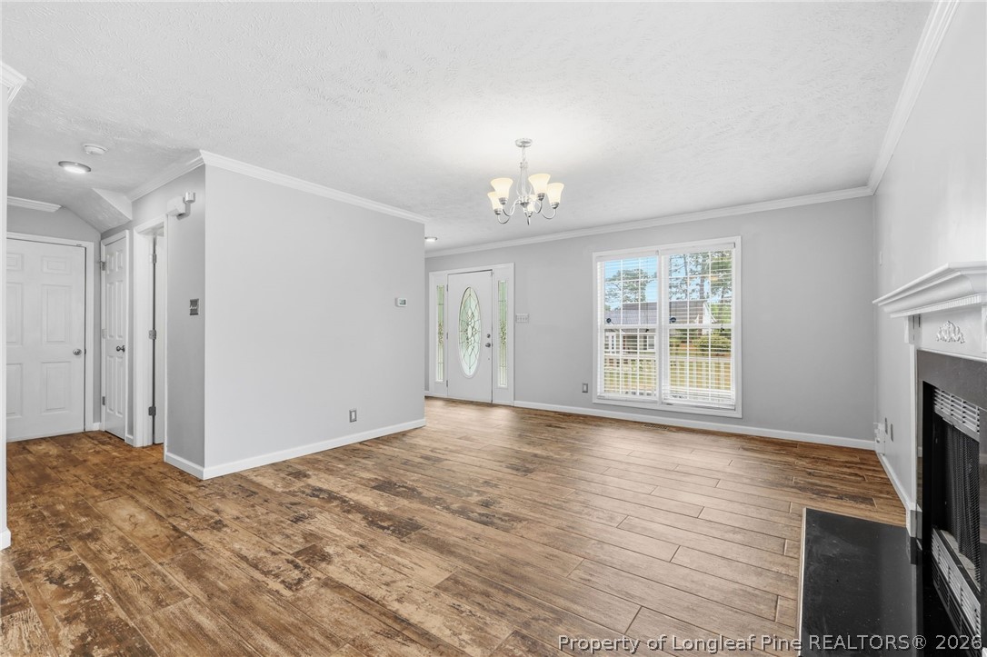5113 Archer Road Hope Mills, NC 28348 - Photo 13 of 41 a view of livingroom with window fireplace and wooden floor