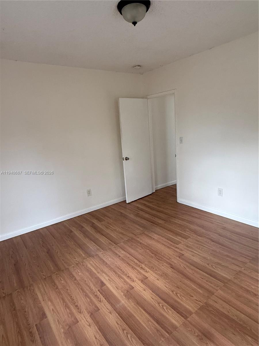 520 Northeast 82nd Terrace, Unit 10 Miami, FL 33138 - Photo 10 of 11 a view of an empty room with wooden floor