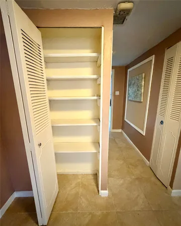 a view of a room with a door and a door