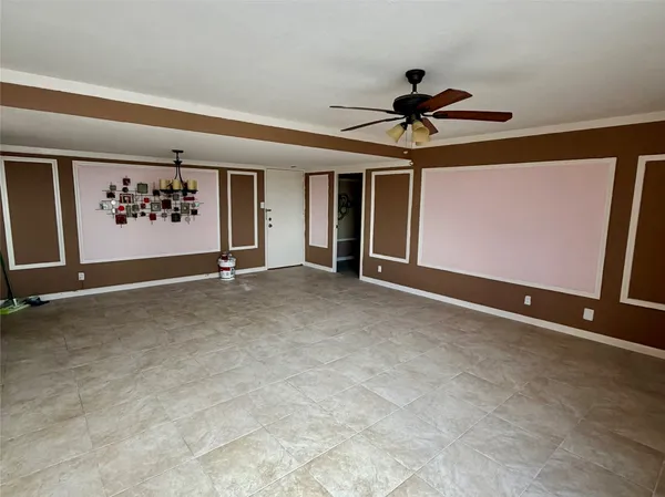 a view of a livingroom with a ceiling fan and window