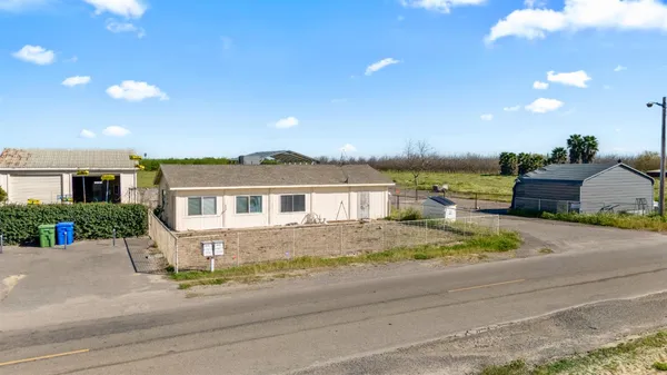 a front view of a house with a garden and yard