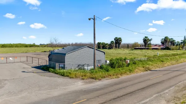 a view of a house with a yard and a street