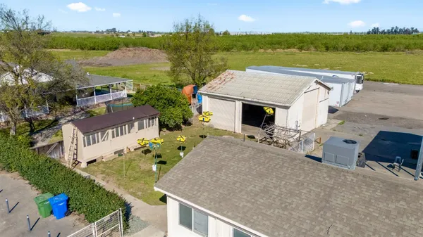 an aerial view of a house with garden space and outdoor seating
