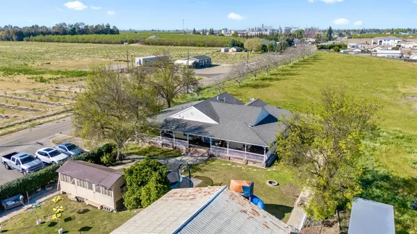 an aerial view of residential houses with outdoor space and ocean view