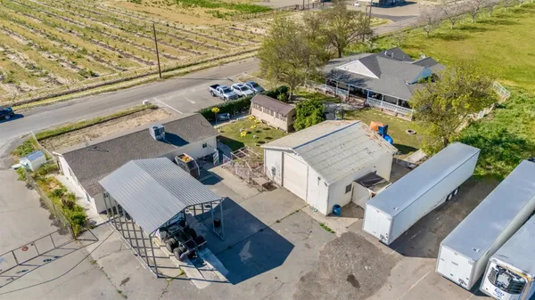 an aerial view of a house with outdoor seating