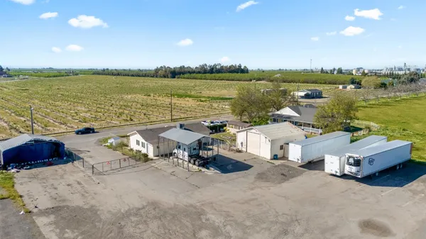 a view of a terrace with lawn chairs