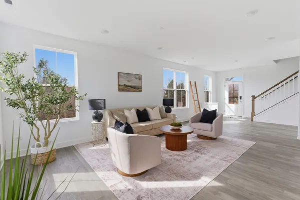 a living room with fireplace furniture and a potted plant