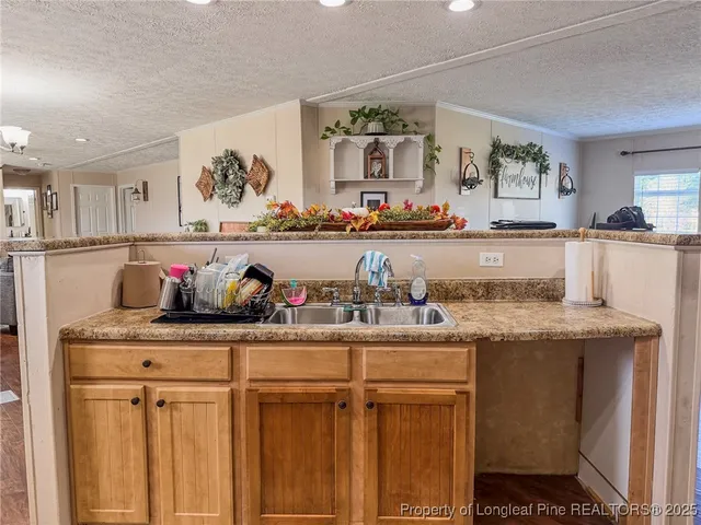 a kitchen with granite countertop lots of white cabinets and stainless steel appliances