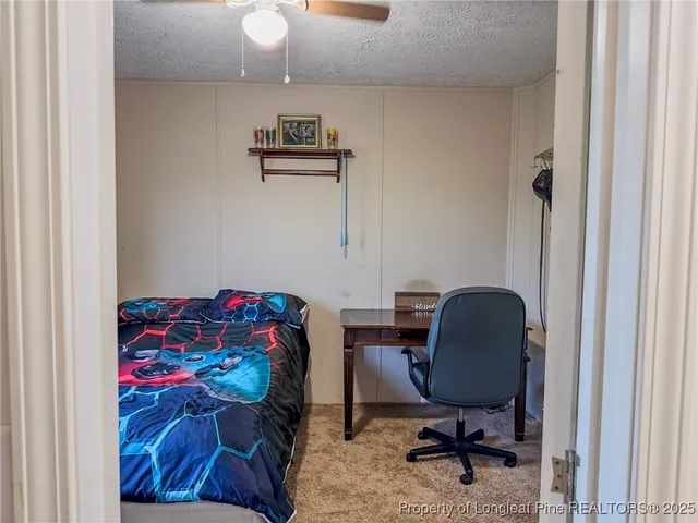 a bedroom with a bed and a chair