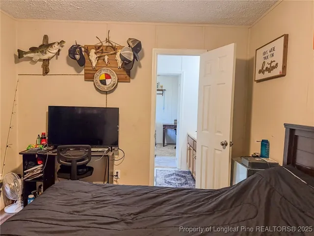 a bedroom with a bed and a desk
