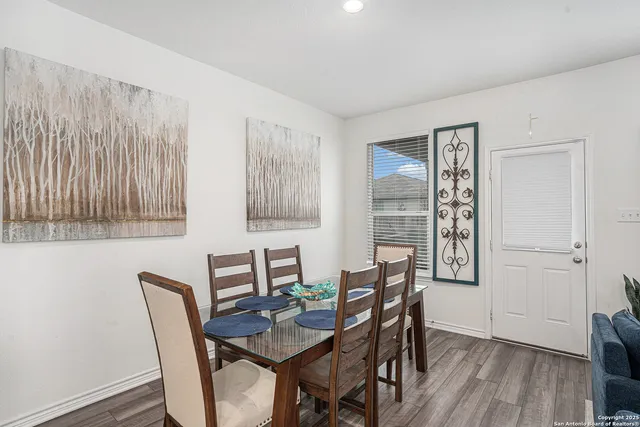 a view of a dining room with furniture and wooden floor