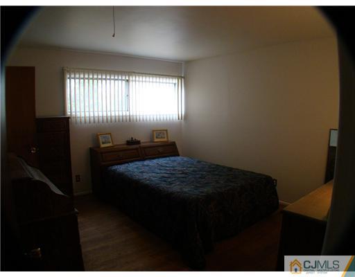 23 Rutgers Road Old Bridge, NJ 08859 - Photo 14 of 21 a room that has a bed and a window