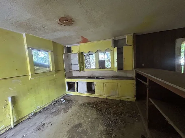 a view of room with a sink and a mirror