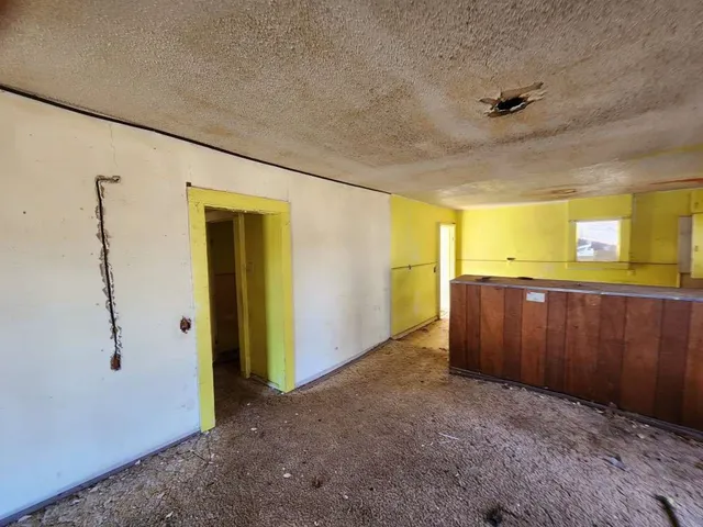 a view of a hallway with closet and wooden floor
