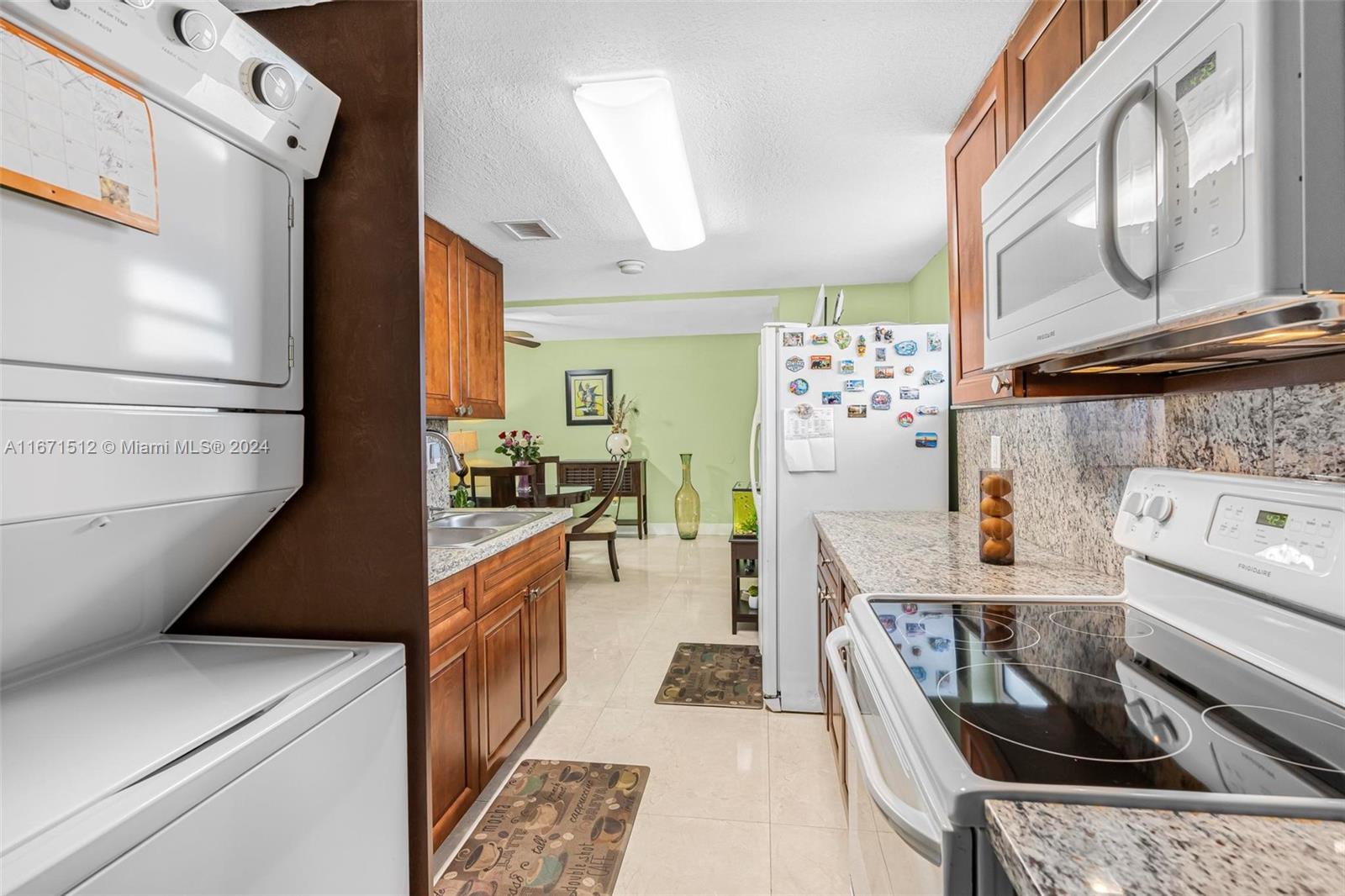 6300 Southwest 138th Court, Unit 307 Miami, FL 33183 - Photo 13 of 30 a kitchen with a stove and a refrigerator