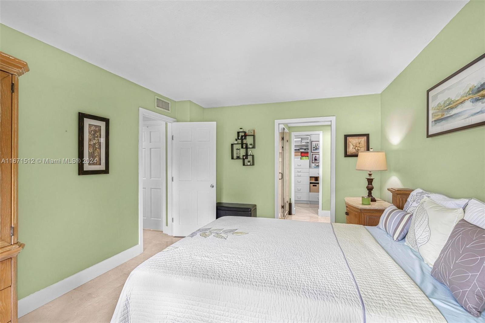 6300 Southwest 138th Court, Unit 307 Miami, FL 33183 - Photo 16 of 30 a bedroom with a bed and painting on the wall