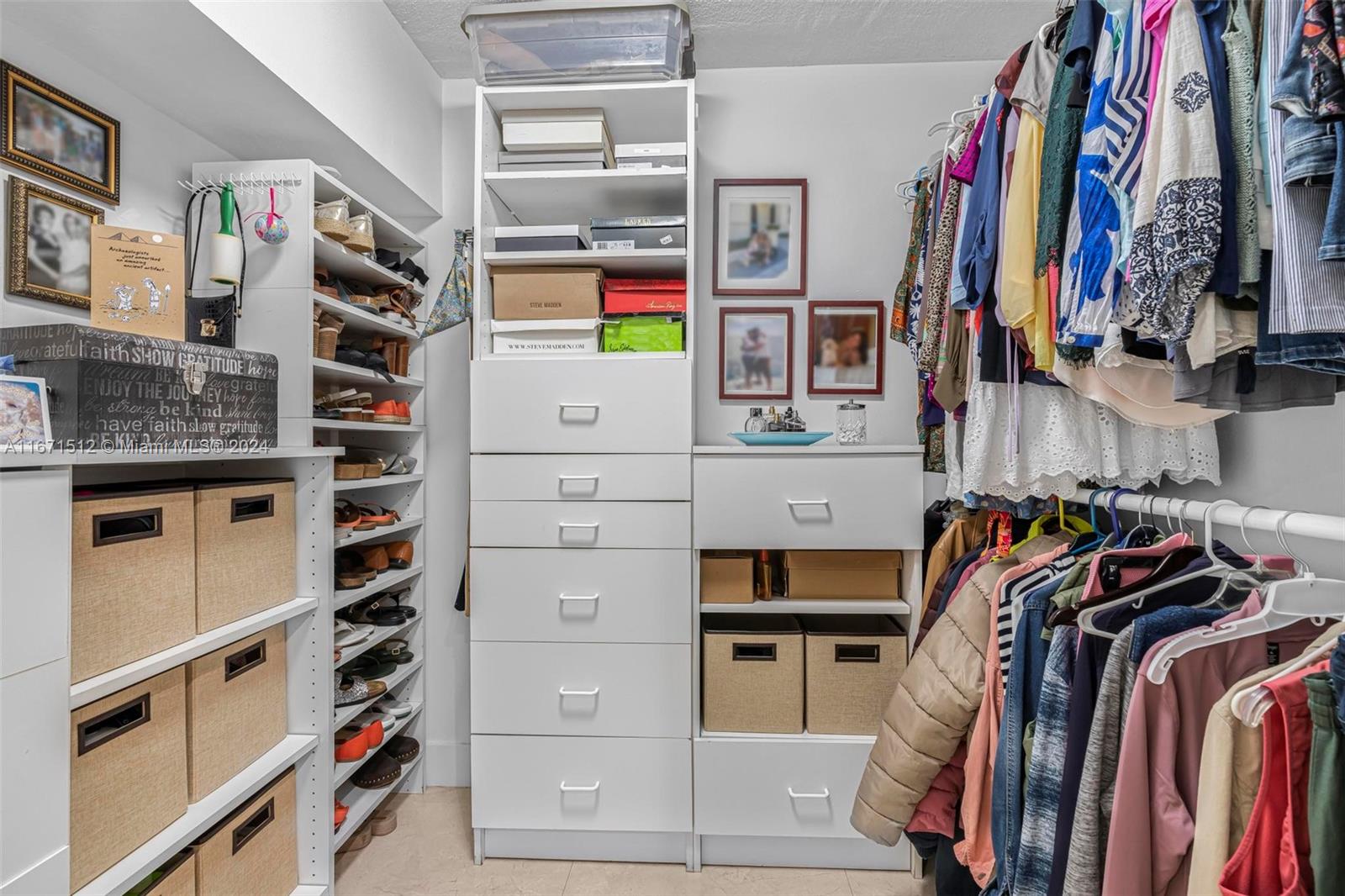 6300 Southwest 138th Court, Unit 307 Miami, FL 33183 - Photo 19 of 30 a view of walk in closet with clothes and shoes