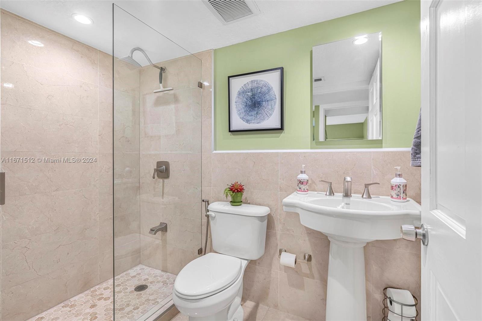 6300 Southwest 138th Court, Unit 307 Miami, FL 33183 - Photo 21 of 30 a bathroom with a toilet sink and mirror