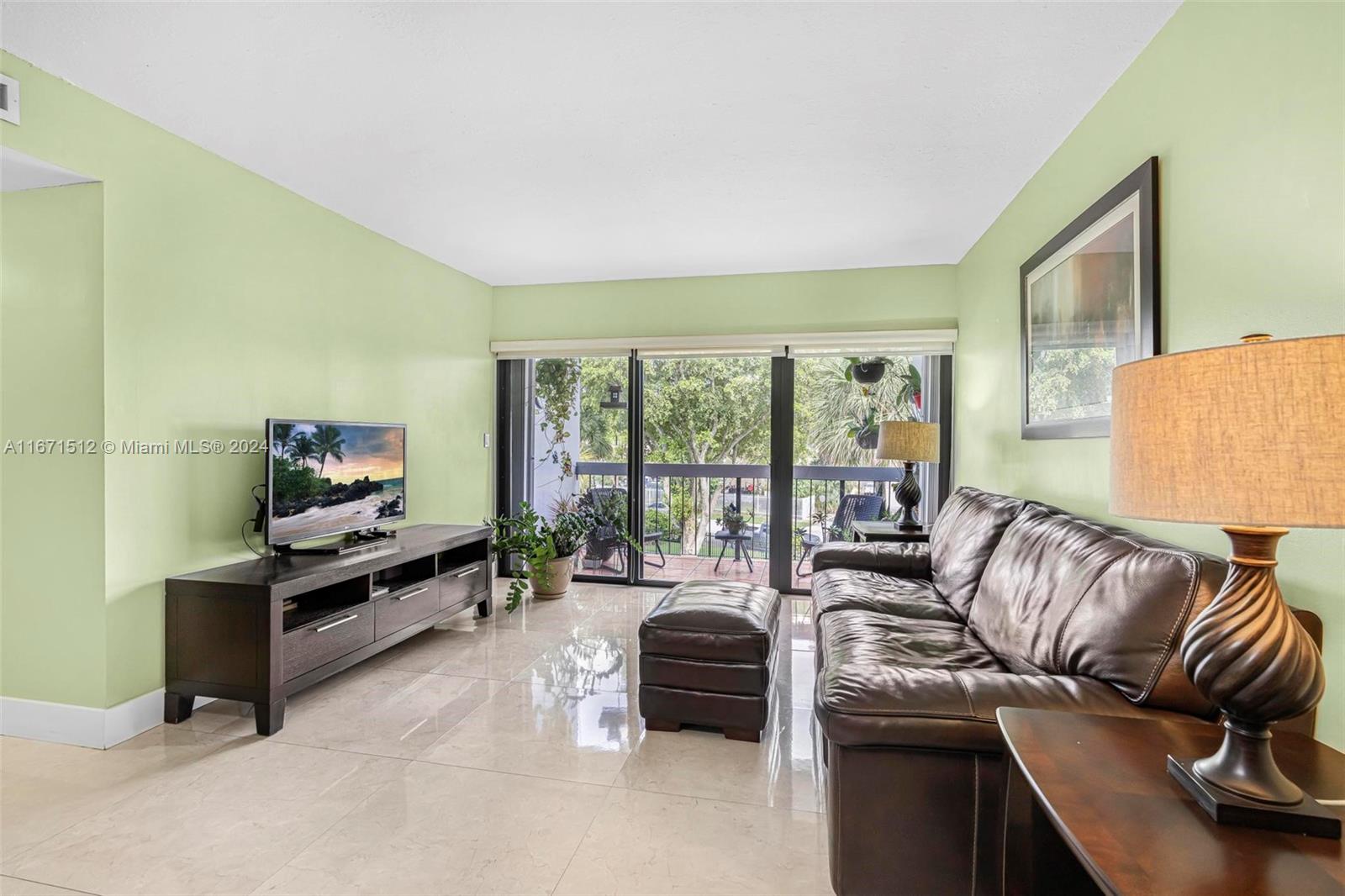 6300 Southwest 138th Court, Unit 307 Miami, FL 33183 - Photo 7 of 30 a living room with furniture and a flat screen tv