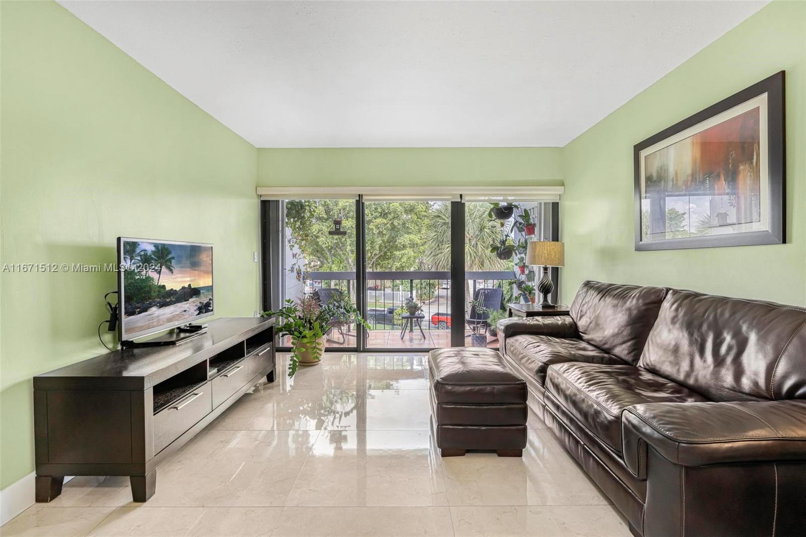 6300 Southwest 138th Court, Unit 307 Miami, FL 33183 - Photo 8 of 30 a living room with furniture and a flat screen tv