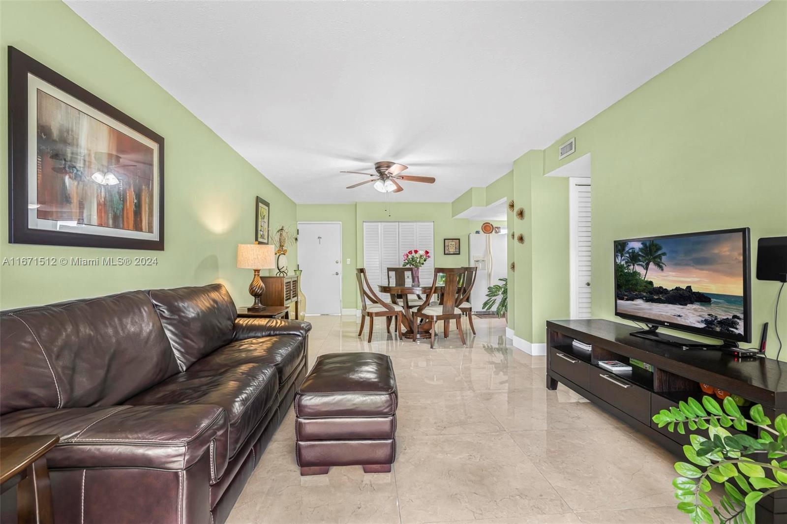 6300 Southwest 138th Court, Unit 307 Miami, FL 33183 - Photo 9 of 30 a living room with furniture and a flat screen tv