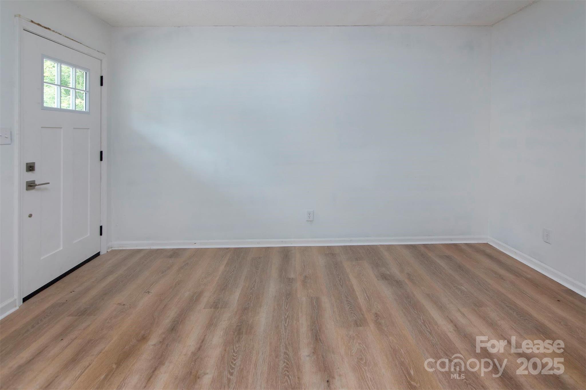 1313 North Main Street, Unit 3 Lowell, NC 28098 - Photo 4 of 10 a view of an empty room and window