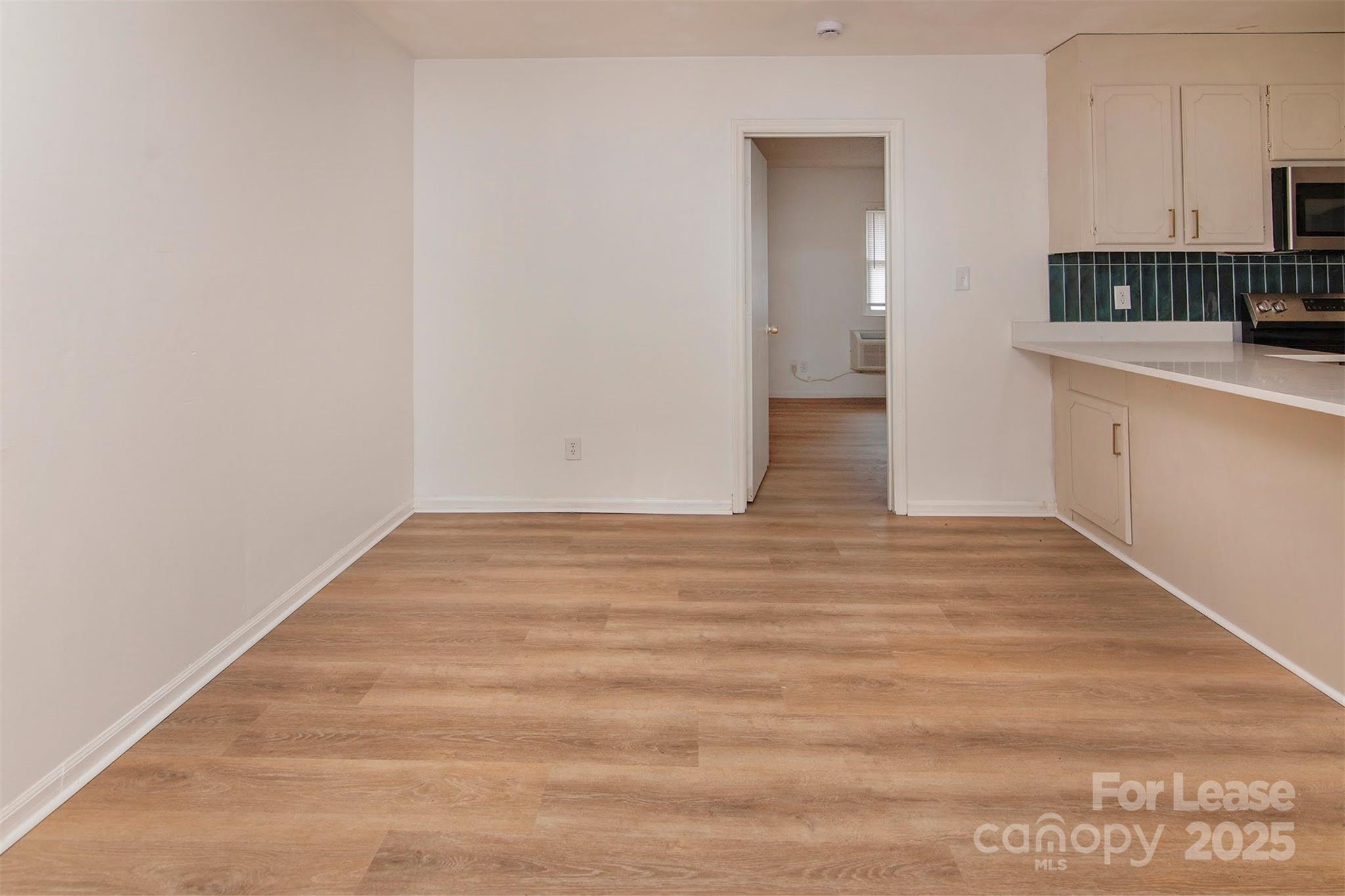 1313 North Main Street, Unit 3 Lowell, NC 28098 - Photo 5 of 10 a view of empty room with wooden floor