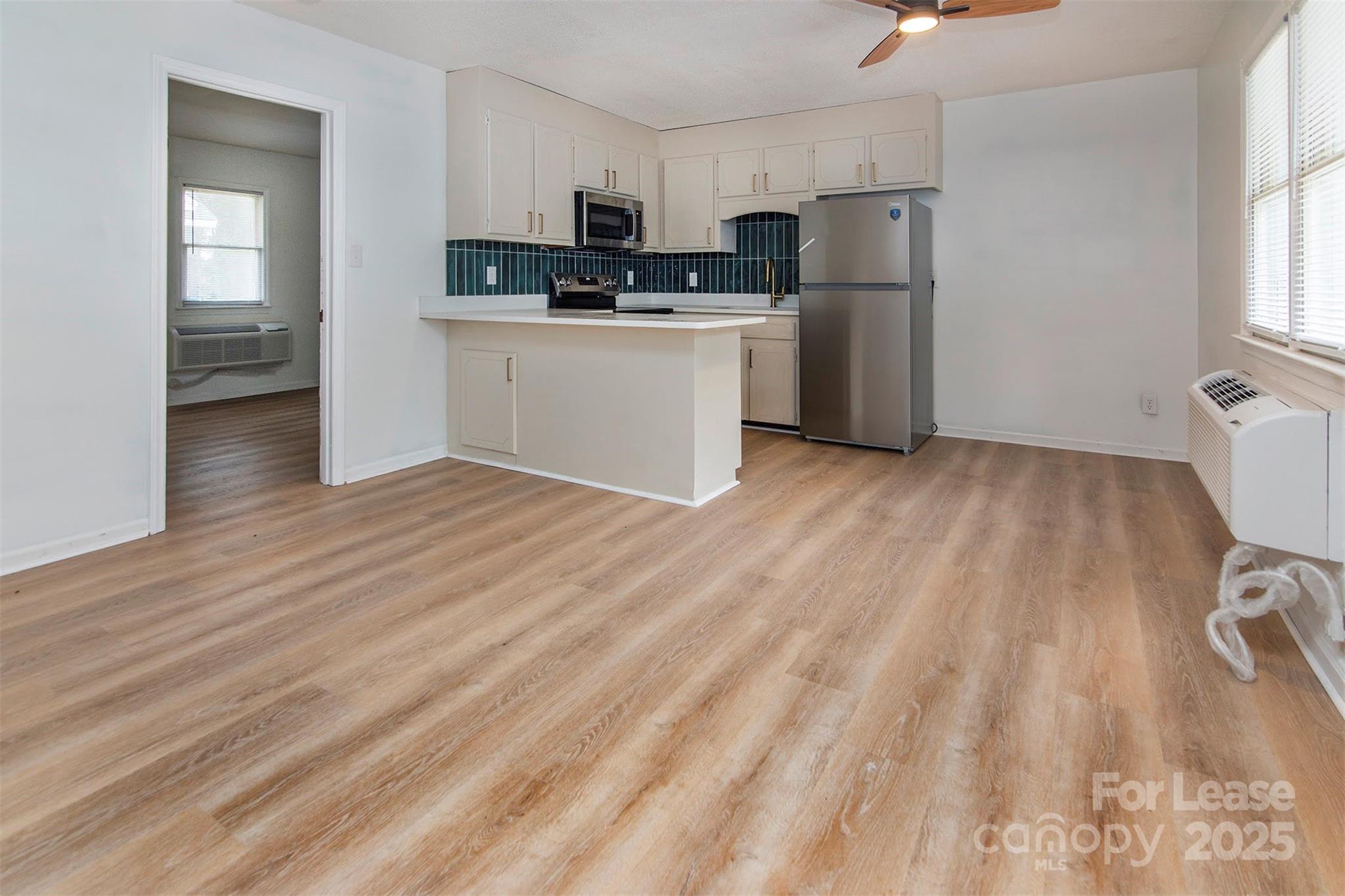 1313 North Main Street, Unit 3 Lowell, NC 28098 - Photo 7 of 10 a kitchen with stainless steel appliances a refrigerator and a stove top oven