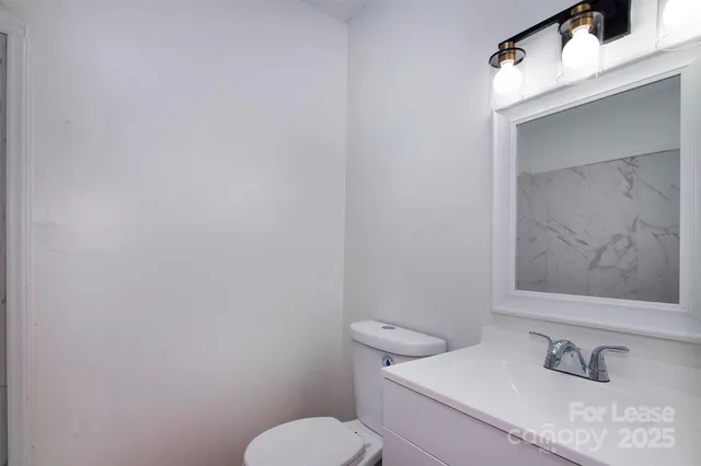 a white toilet sitting next to a bathroom sink