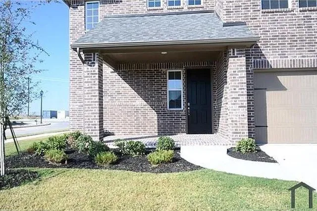 a view of a house with potted plants