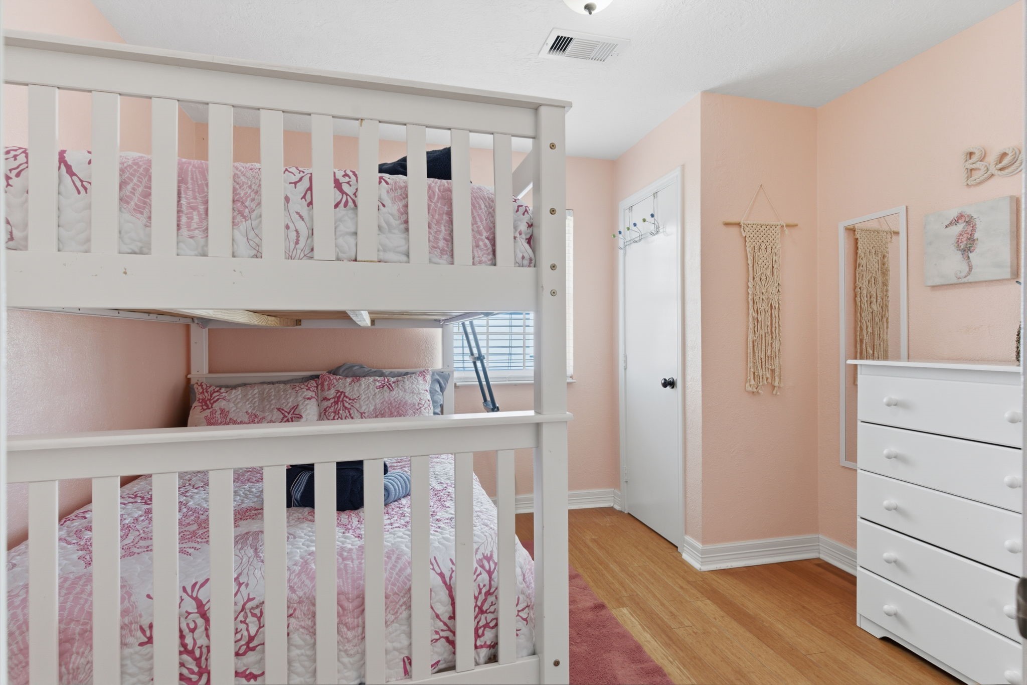315 Caisson Street Surfside Beach, TX 77541 - Photo 16 of 32 Secondary Bedroom (Bunk Room) – Cheerful bunk room featuring a space-saving design, soft coastal tones, and natural light—perfect for guests or additional sleeping accommodations.
