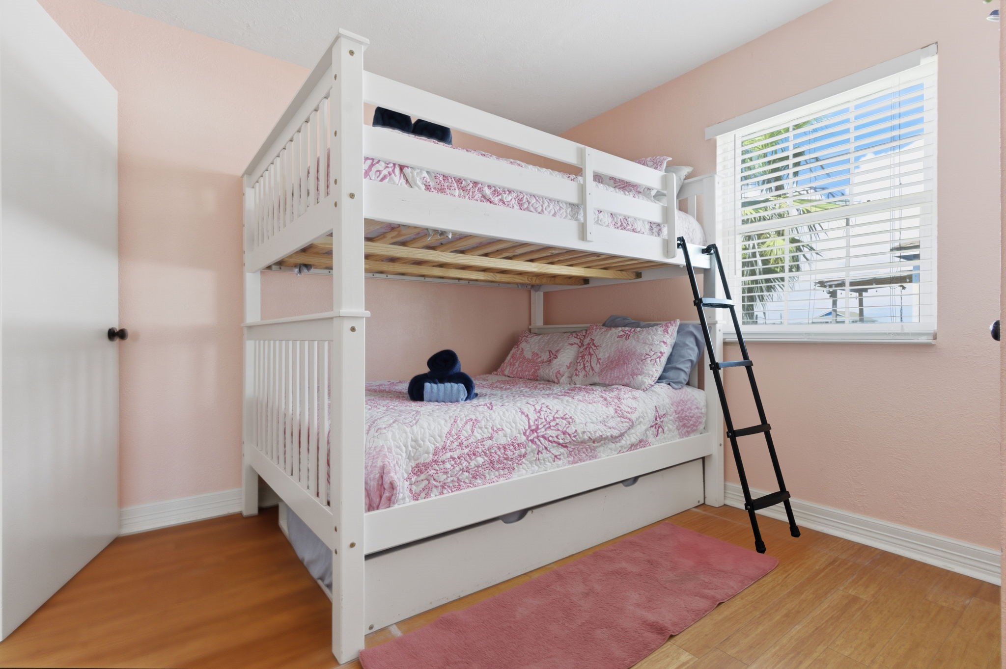 315 Caisson Street Surfside Beach, TX 77541 - Photo 17 of 32 Secondary Bedroom (Alternate View) – Bright and inviting bunk room with clean finishes and a functional layout that maximizes sleeping space while maintaining comfort.