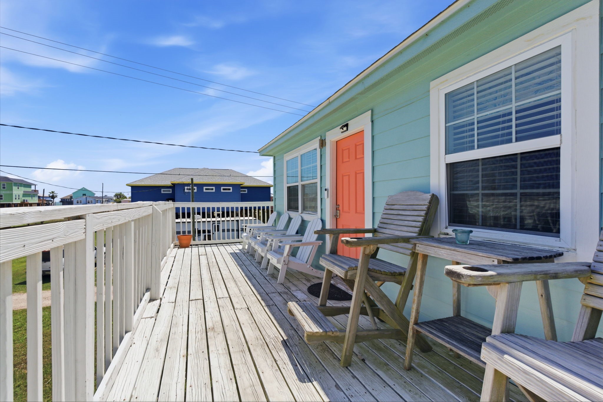 315 Caisson Street Surfside Beach, TX 77541 - Photo 26 of 32 Front Deck (Exterior View) – Welcoming entry deck with ample room for seating and outdoor enjoyment, enhancing the home’s coastal charm.