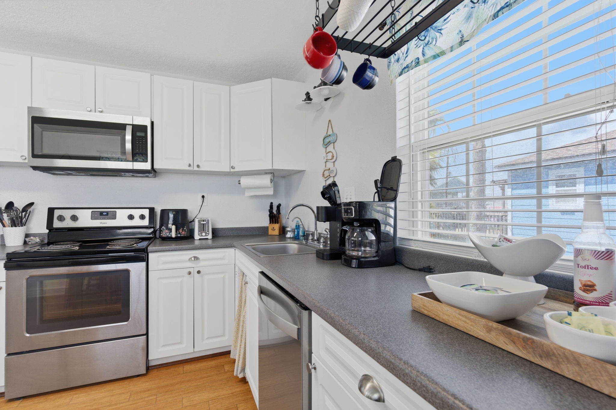 315 Caisson Street Surfside Beach, TX 77541 - Photo 8 of 32 Kitchen (Counter & Sink Area) – Well-lit workspace with generous countertops, double sink, and window views that bring in natural light, making meal prep both practical and pleasant.