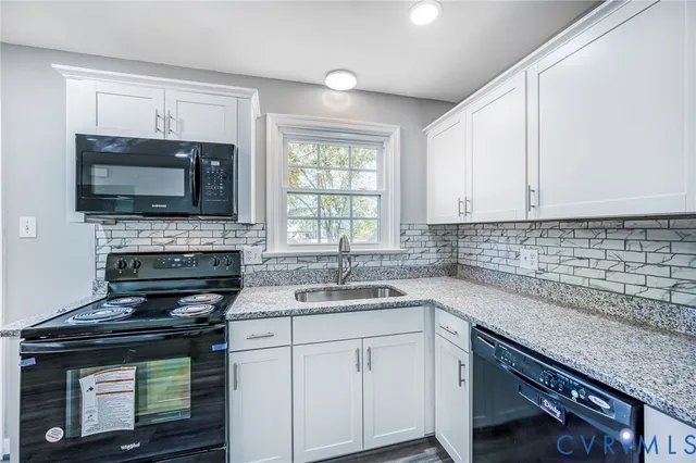 a kitchen with a sink stove and microwave
