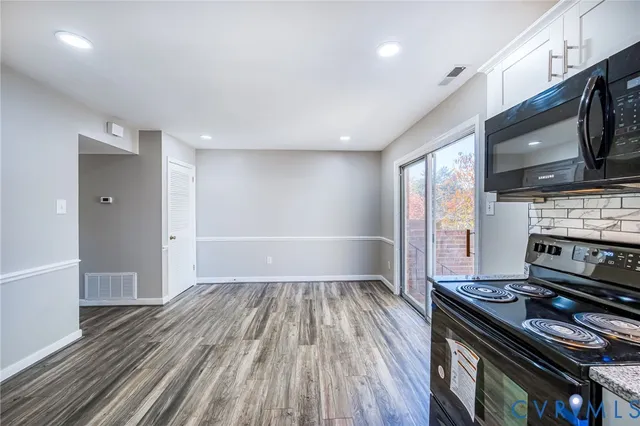 a kitchen with wooden floors and appliances
