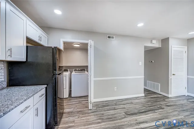 a kitchen with a refrigerator and a sink