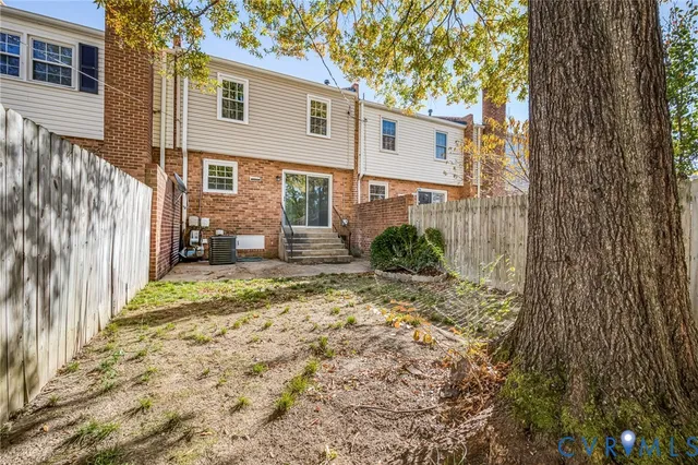 a backyard of a house with table and chairs