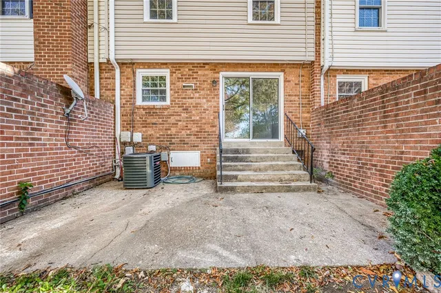 a view of a house with stairs and wooden fence