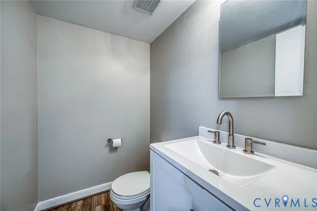 a bathroom with a sink a toilet and mirror