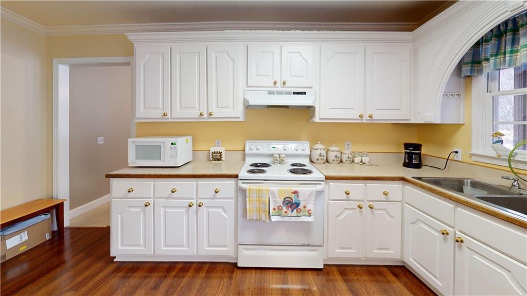 24 Austin Way Jefferson, GA 30549 - Photo 11 of 31 a kitchen with a sink a stove and cabinets