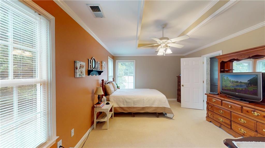 24 Austin Way Jefferson, GA 30549 - Photo 16 of 31 a bedroom with a bed and a flat screen tv