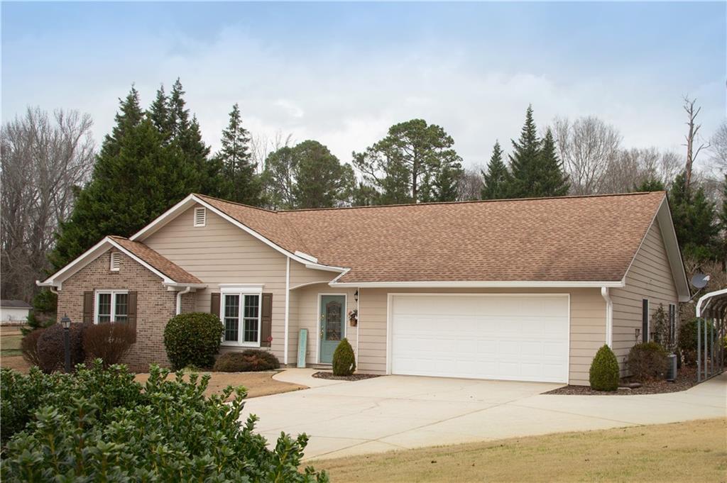 24 Austin Way Jefferson, GA 30549 - Photo 2 of 31 a front view of a house with a yard and garage