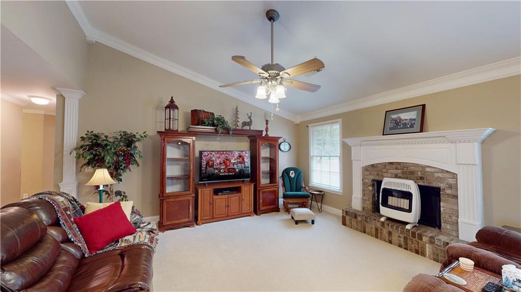 24 Austin Way Jefferson, GA 30549 - Photo 5 of 31 a living room with furniture a fireplace and a flat screen tv