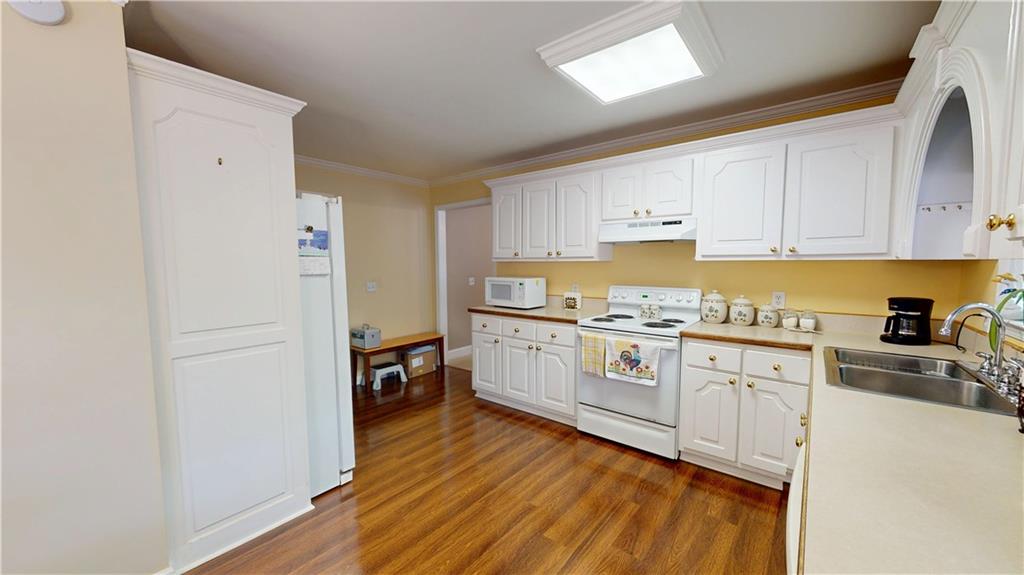 24 Austin Way Jefferson, GA 30549 - Photo 10 of 31 a kitchen with granite countertop white cabinets and white appliances