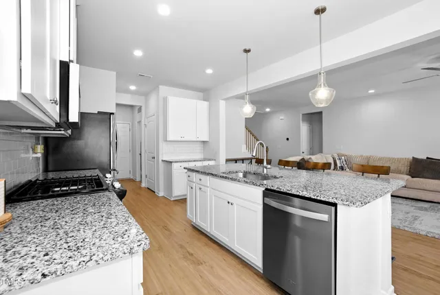 a kitchen with a sink stove and refrigerator