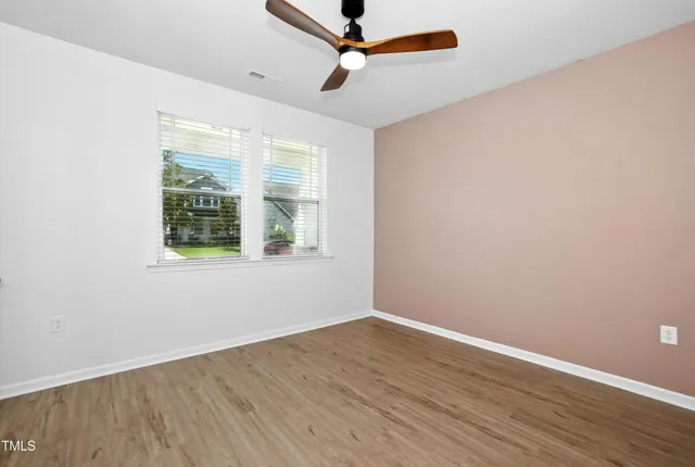 wooden floor in an empty room with a window