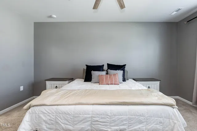 a bedroom with a bed and a lamp